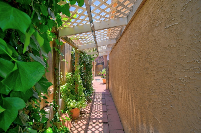 6749 Kelly Ann Rd NE, Albuquerque, NM 87109 - view of side of home featuring a pergola, stucco siding, and a patio