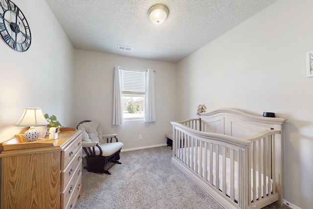 1854 Valle Vista Rd NW, Los Lunas, NM 87031 - bedroom with a textured ceiling, carpet flooring, and a crib
