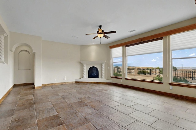 2413 Desert View Rd NE, Rio Rancho, NM 87144 - unfurnished living room featuring a ceiling fan and a glass covered fireplace