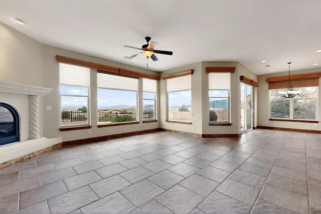 2413 Desert View Rd NE, Rio Rancho, NM 87144 - unfurnished living room featuring healthy amount of natural light, ceiling fan, a premium fireplace, a chandelier, and recessed lighting