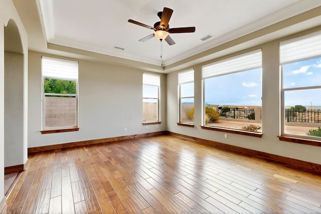 2413 Desert View Rd NE, Rio Rancho, NM 87144 - unfurnished room featuring a tray ceiling, healthy amount of natural light, ornamental molding, and wood finished floors