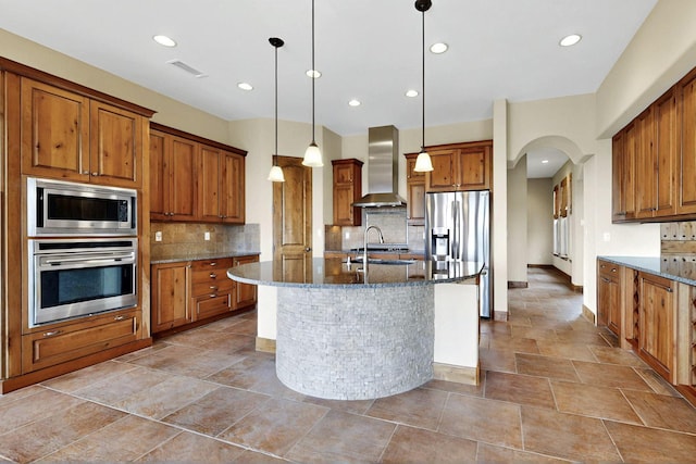 2413 Desert View Rd NE, Rio Rancho, NM 87144 - kitchen with appliances with stainless steel finishes, wall chimney exhaust hood, brown cabinets, and recessed lighting