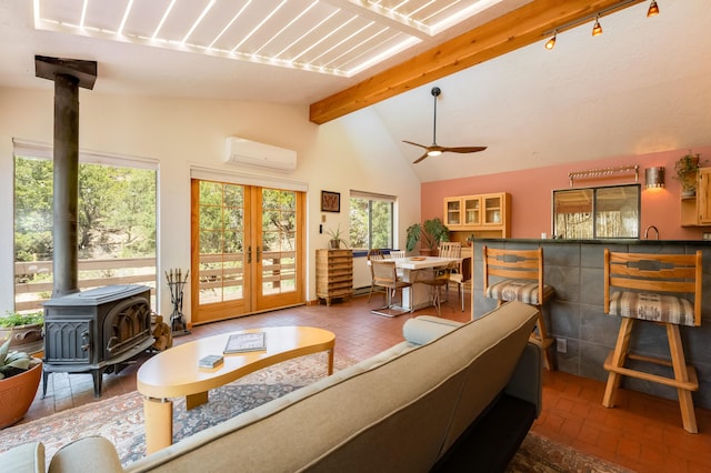 23 Cooper Rd, Cedar Crest, NM 87008 - living room featuring a wood stove, a wall mounted air conditioner, a ceiling fan, french doors, and brick patterned flooring