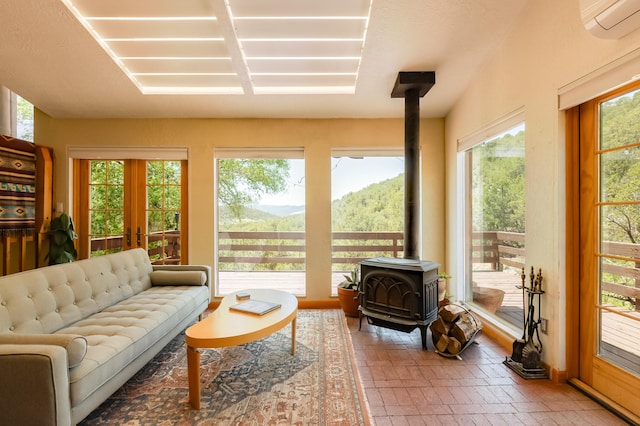 23 Cooper Rd, Cedar Crest, NM 87008 - living area with a wood stove, brick patterned flooring, and a wall unit AC