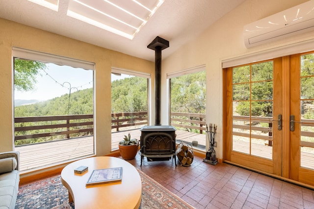 23 Cooper Rd, Cedar Crest, NM 87008 - sunroom featuring a wall mounted AC, a wood stove, french doors, and lofted ceiling