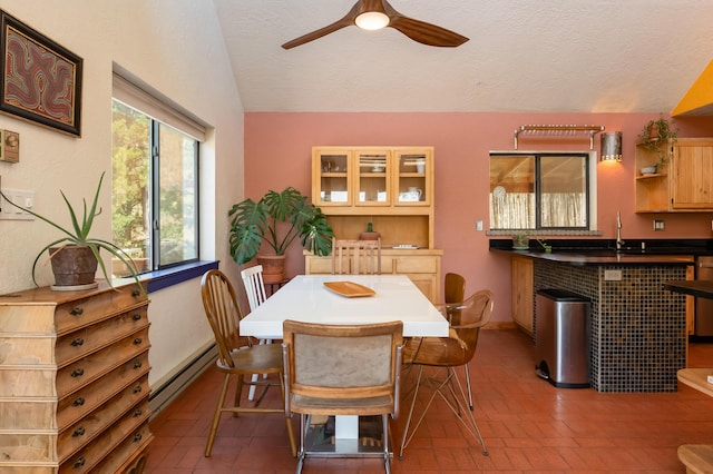 23 Cooper Rd, Cedar Crest, NM 87008 - dining room with lofted ceiling, ceiling fan, baseboard heating, and a textured ceiling