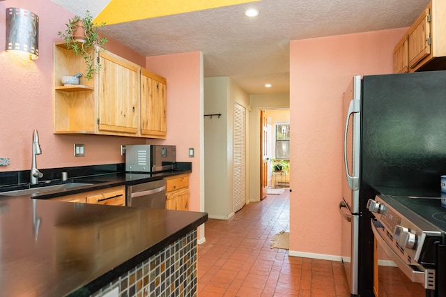 23 Cooper Rd, Cedar Crest, NM 87008 - kitchen featuring appliances with stainless steel finishes, light brown cabinets, a textured ceiling, dark countertops, and open shelves
