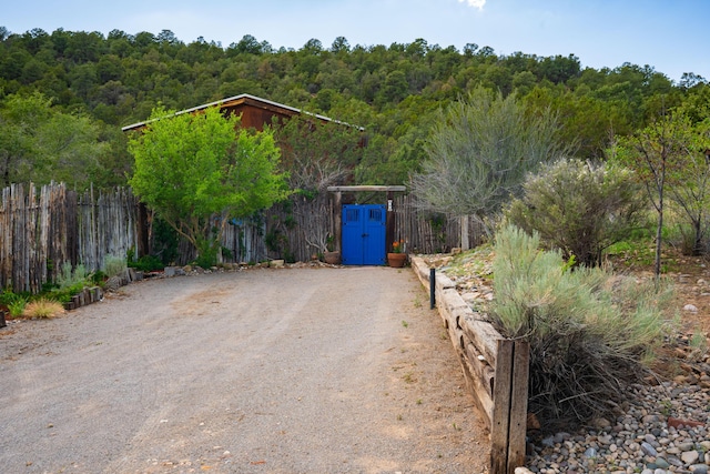 23 Cooper Rd, Cedar Crest, NM 87008 - view of dirt / gravel driveway featuring a forest view