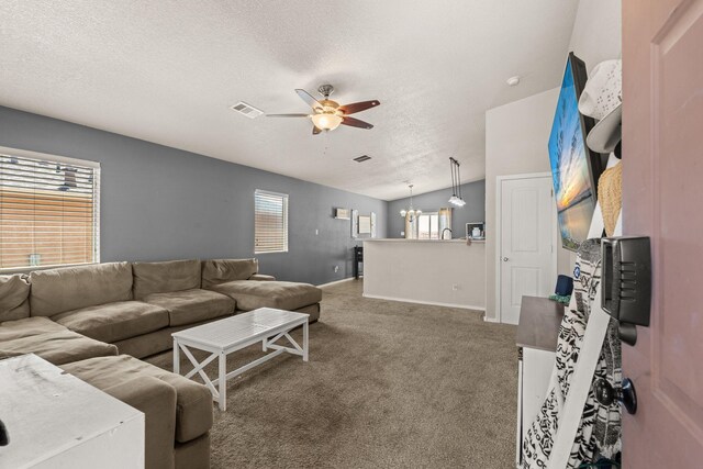 10732 Beaker Rd SW, Albuquerque, NM 87121 - carpeted living area with a ceiling fan, a textured ceiling, and a chandelier