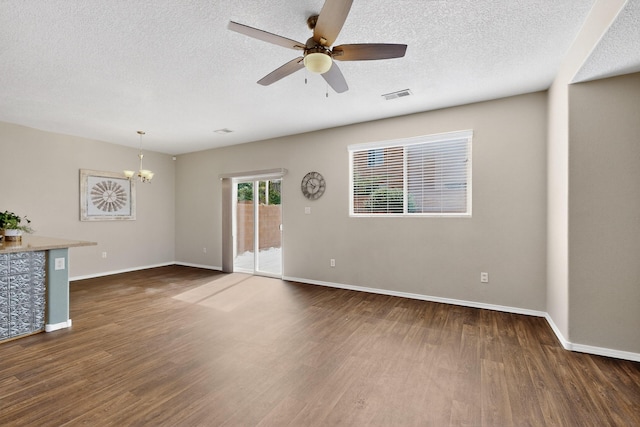 2353 Cortina Loop SE, Rio Rancho, NM 87124 - unfurnished living room with wood finished floors, a chandelier, ceiling fan, and a textured ceiling
