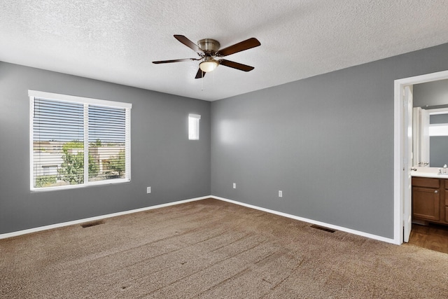 2353 Cortina Loop SE, Rio Rancho, NM 87124 - carpeted spare room with a ceiling fan and a textured ceiling