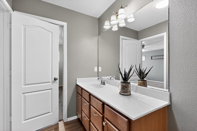 2353 Cortina Loop SE, Rio Rancho, NM 87124 - bathroom with vanity, wood finished floors, a ceiling fan, and a textured wall