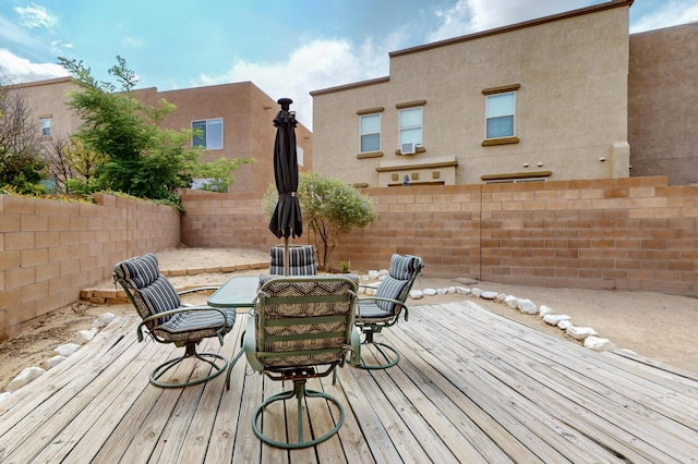 2353 Cortina Loop SE, Rio Rancho, NM 87124 - wooden deck with a fenced backyard and outdoor dining space