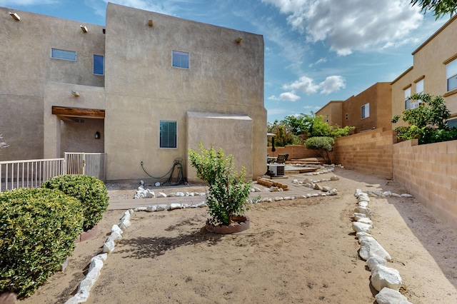 2353 Cortina Loop SE, Rio Rancho, NM 87124 - back of house with a fenced backyard and stucco siding
