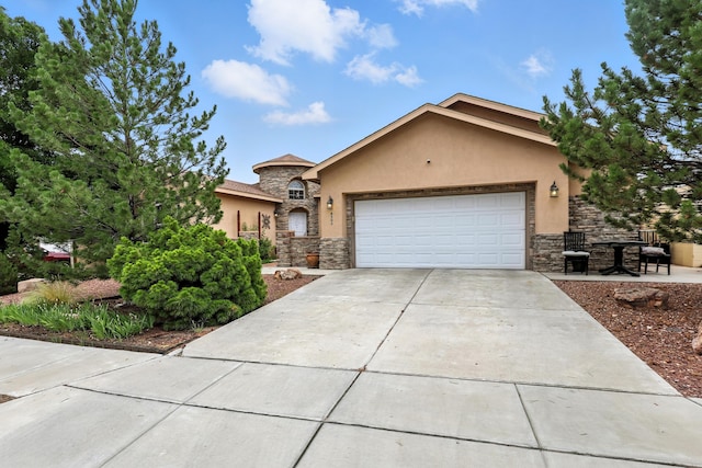 8500 Clarks Fork Rd NW, Albuquerque, NM 87120 - view of front facade featuring stone siding, stucco siding, a garage, and driveway