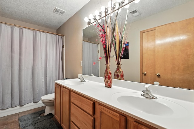 8500 Clarks Fork Rd NW, Albuquerque, NM 87120 - bathroom featuring a textured ceiling, double vanity, and tile patterned flooring