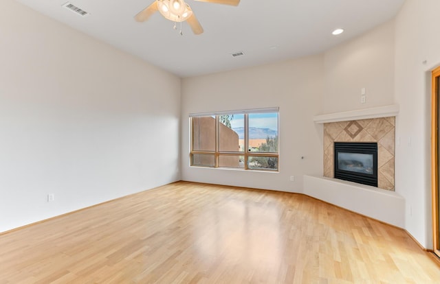 31 Wind Rd NW, Albuquerque, NM 87120 - unfurnished living room featuring wood finished floors, ceiling fan, a glass covered fireplace, and recessed lighting