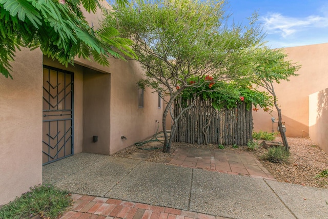 31 Wind Rd NW, Albuquerque, NM 87120 - property entrance featuring stucco siding, a patio area, and a gate