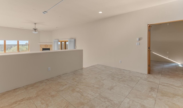 31 Wind Rd NW, Albuquerque, NM 87120 - unfurnished room featuring a ceiling fan, a tile fireplace, and recessed lighting