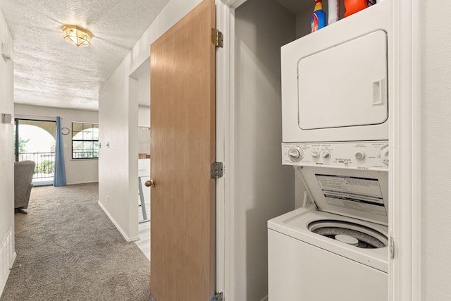 805 Country Club Dr SE Unit G2, Rio Rancho, NM 87124 - laundry room featuring stacked washing machine and dryer, a textured ceiling, and carpet floors