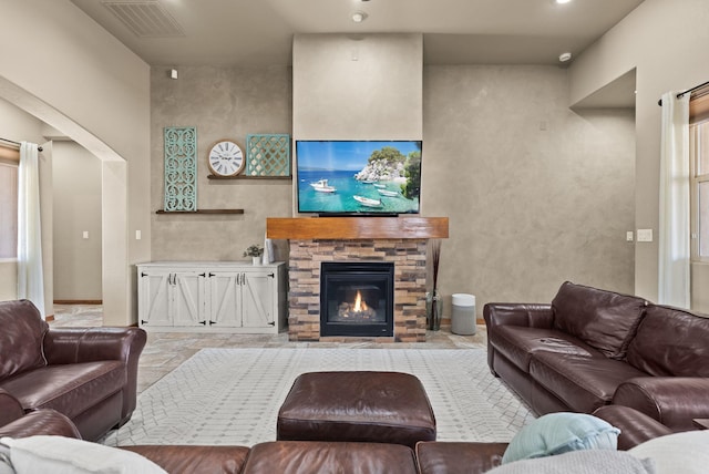 9844 Cameron St NW, Albuquerque, NM 87114 - living room with arched walkways and a stone fireplace