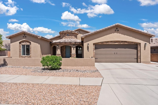 9844 Cameron St NW, Albuquerque, NM 87114 - mediterranean / spanish-style house with stucco siding, stone siding, a garage, driveway, and a tile roof