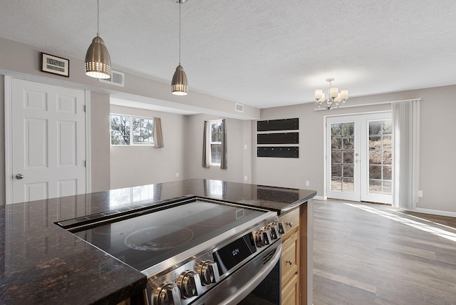 40 Mulberry Loop, Cedar Crest, NM 87008 - kitchen with stainless steel electric range oven, wood finished floors, a textured ceiling, a chandelier, and pendant lighting