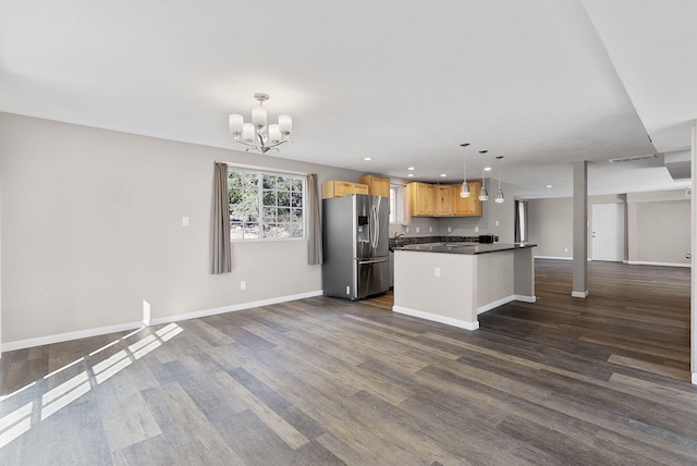 40 Mulberry Loop, Cedar Crest, NM 87008 - kitchen featuring stainless steel refrigerator with ice dispenser, open floor plan, dark countertops, a chandelier, and dark wood-type flooring