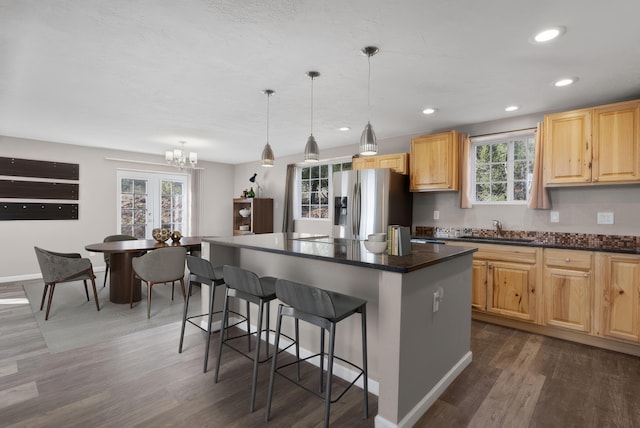 40 Mulberry Loop, Cedar Crest, NM 87008 - kitchen featuring a breakfast bar area, stainless steel fridge with ice dispenser, healthy amount of natural light, dark wood-type flooring, and recessed lighting