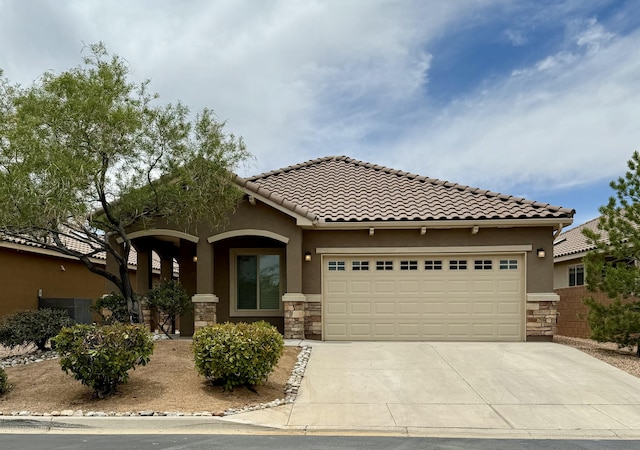 827 Purple Aster Dr, Bernalillo, NM 87004 - mediterranean / spanish-style house featuring stone siding, driveway, stucco siding, and an attached garage