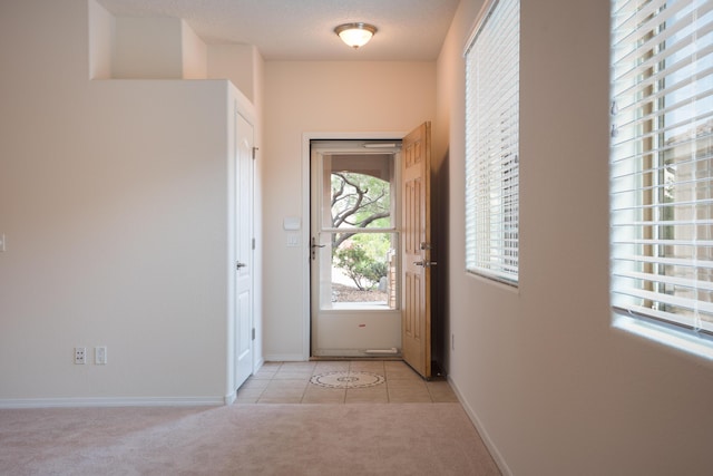 827 Purple Aster Dr, Bernalillo, NM 87004 - doorway with light colored carpet and light tile patterned flooring