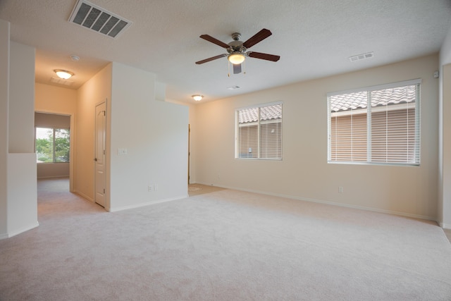 827 Purple Aster Dr, Bernalillo, NM 87004 - spare room featuring ceiling fan, light carpet, and a textured ceiling