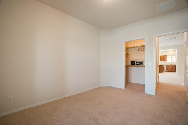 827 Purple Aster Dr, Bernalillo, NM 87004 - unfurnished bedroom with light colored carpet and a walk in closet