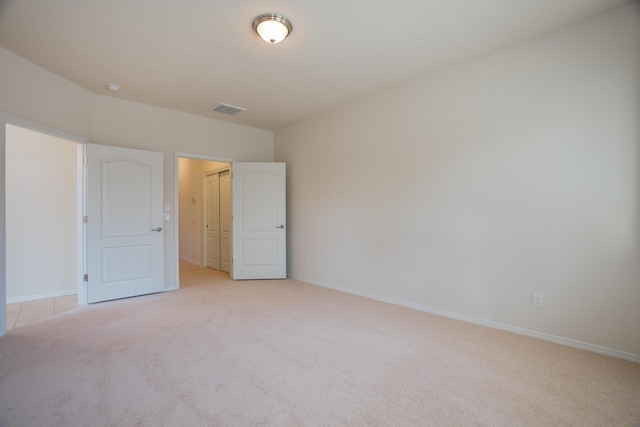 827 Purple Aster Dr, Bernalillo, NM 87004 - unfurnished bedroom featuring light carpet and baseboards