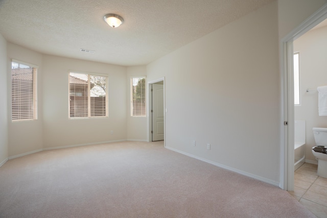 827 Purple Aster Dr, Bernalillo, NM 87004 - empty room featuring light colored carpet and a textured ceiling