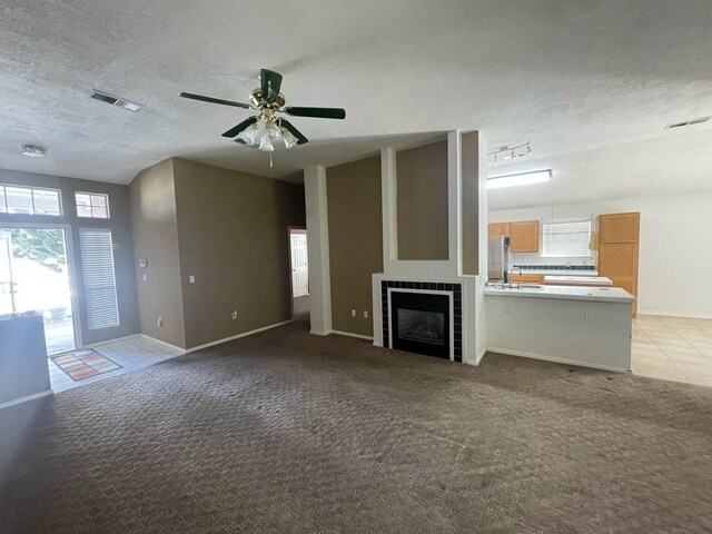 45 Juniper Ave, Los Lunas, NM 87031 - unfurnished living room featuring plenty of natural light, a textured ceiling, light colored carpet, and a ceiling fan