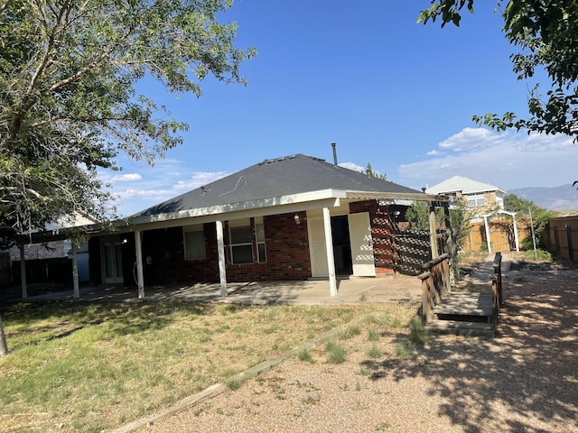 45 Juniper Ave, Los Lunas, NM 87031 - back of property featuring a patio area and brick siding