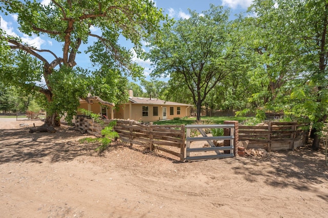 697 W W Meadowlark Ln, Corrales, NM 87048 - view of front facade with stucco siding and a chimney