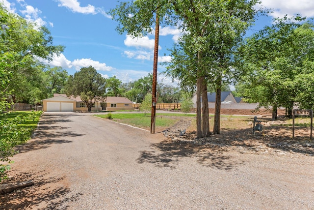 697 W W Meadowlark Ln, Corrales, NM 87048 - view of front of home with driveway and an attached garage