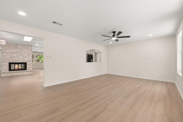 697 W W Meadowlark Ln, Corrales, NM 87048 - unfurnished living room with light wood finished floors, a ceiling fan, a multi sided fireplace, and recessed lighting