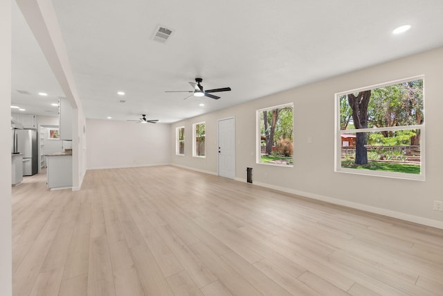 697 W W Meadowlark Ln, Corrales, NM 87048 - unfurnished living room with recessed lighting, a ceiling fan, and light wood-style flooring