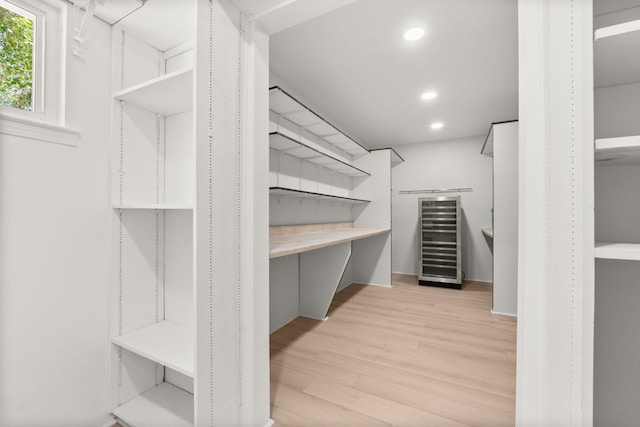 697 W W Meadowlark Ln, Corrales, NM 87048 - walk in closet with light wood-style flooring and wine cooler