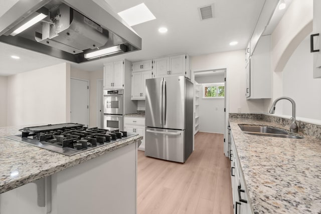 697 W W Meadowlark Ln, Corrales, NM 87048 - kitchen featuring stainless steel appliances, extractor fan, white cabinets, light wood-style flooring, and recessed lighting