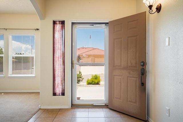 5485 Roosevelt Loop NE, Rio Rancho, NM 87144 - foyer entrance with arched walkways, light tile patterned flooring, and light colored carpet