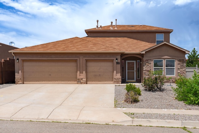 5485 Roosevelt Loop NE, Rio Rancho, NM 87144 - view of front of property with stone siding, driveway, stucco siding, and a garage