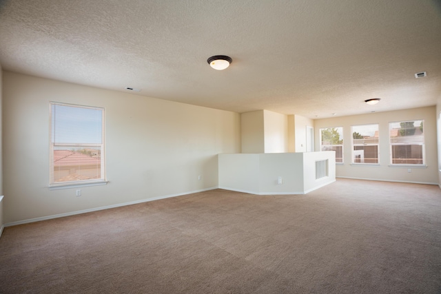 5485 Roosevelt Loop NE, Rio Rancho, NM 87144 - unfurnished living room featuring a textured ceiling and carpet flooring
