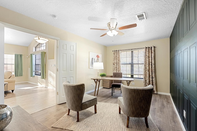 4432 La Paloma Rd NW, Albuquerque, NM 87120 - office space featuring healthy amount of natural light, a ceiling fan, light wood-type flooring, and a textured ceiling