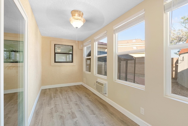4432 La Paloma Rd NW, Albuquerque, NM 87120 - unfurnished sunroom with healthy amount of natural light and a wall mounted air conditioner