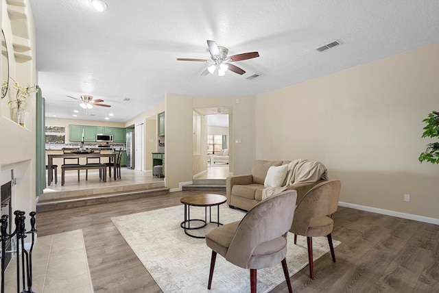 4432 La Paloma Rd NW, Albuquerque, NM 87120 - living room with ceiling fan, light wood-style flooring, and healthy amount of natural light