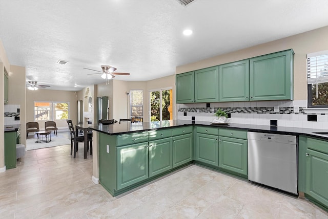 4432 La Paloma Rd NW, Albuquerque, NM 87120 - kitchen with stainless steel dishwasher, ceiling fan, a peninsula, backsplash, and dark countertops